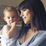 A loving moment between a mother and her child in an indoor setting, fostering connection and warmth.